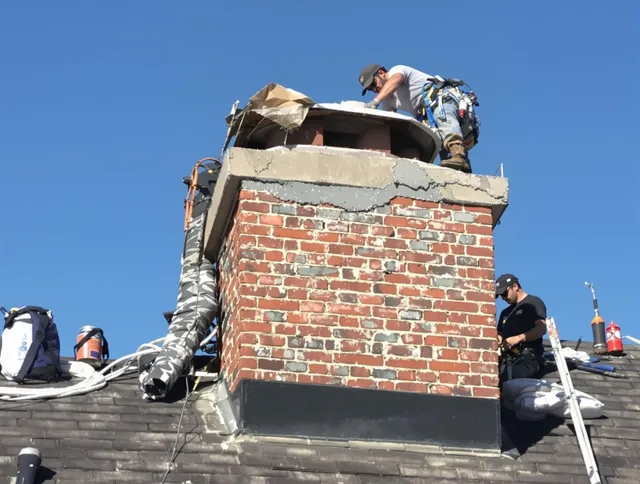 Cheshire Chimney Sweep installing a custom chimney crown in Cheshire, CT