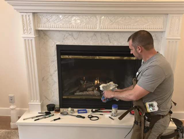 Cheshire Chimney Sweep performing fireplace maintenance in Cheshire, CT